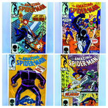 Load image into Gallery viewer, Four comic book covers featuring 'The Amazing Spider-Man' with different superhero poses and colors.
