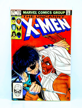 Load image into Gallery viewer, Comic book cover of &#39;The Uncanny X-Men&#39; with two characters facing each other on a red background.
